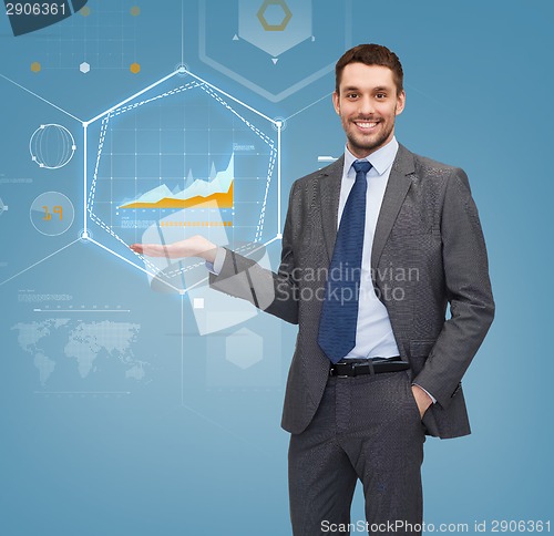 Image of businessman showing graph on virtual screen