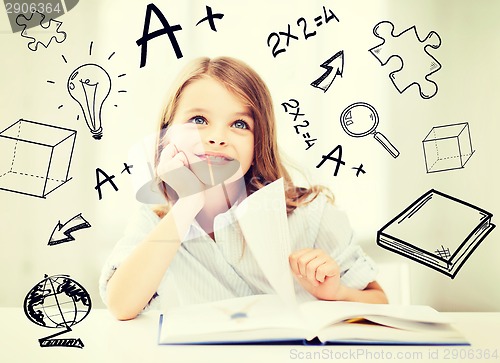 Image of little student girl studying at school