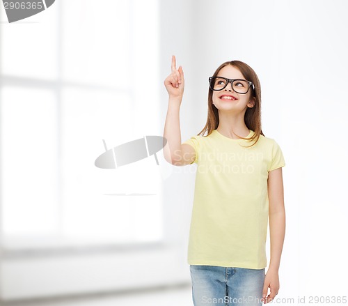 Image of smiling cute little girl in black eyeglasses