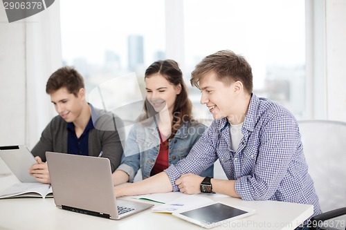 Image of students with laptop, notebooks and tablet pc