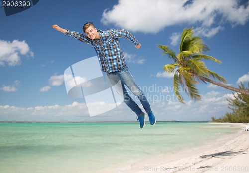 Image of smiling young man flying in air