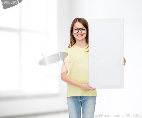 Image of little girl wearing eyeglasses with blank board