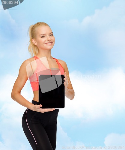 Image of smiling woman showing tablet pc blank screen