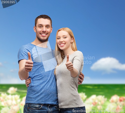 Image of smiling couple showing thumbs up
