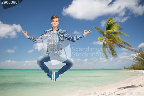 Image of smiling young man jumping in air