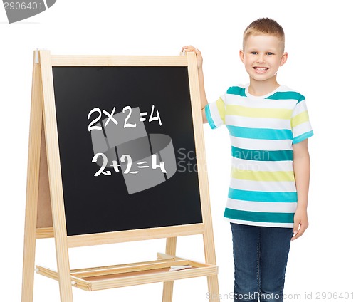 Image of smiling little boy with blank blackboard