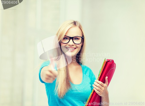 Image of smiling student with folders