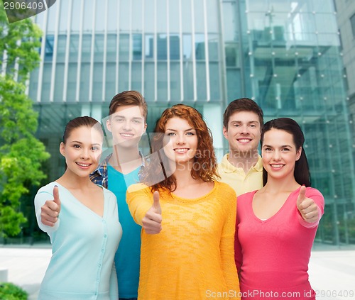 Image of group of smiling teenagers over city background