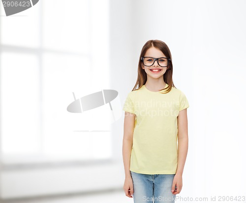 Image of smiling cute little girl in black eyeglasses