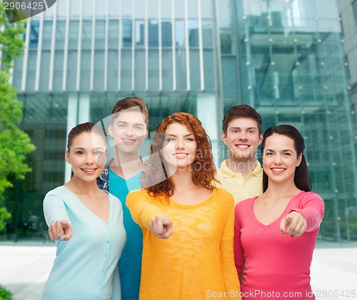 Image of group of smiling teenagers over city background