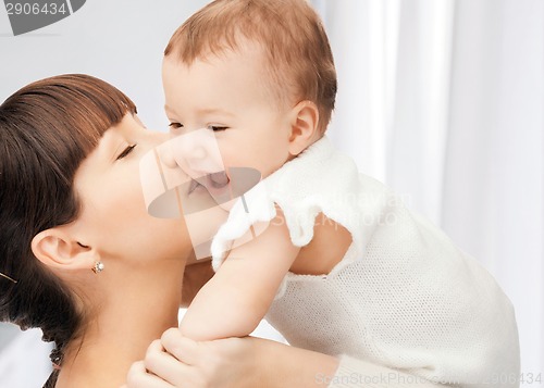 Image of happy mother kissing baby