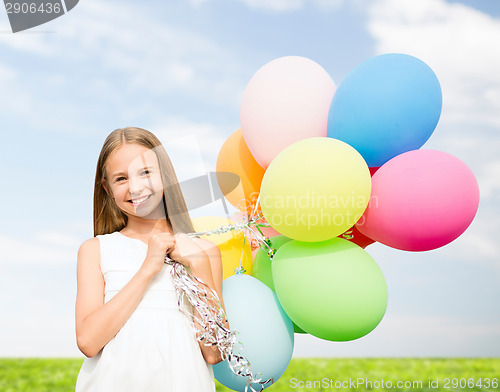 Image of happy girl with colorful balloons