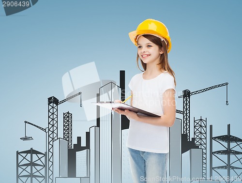 Image of smiling little girl in hardhat with clipboard