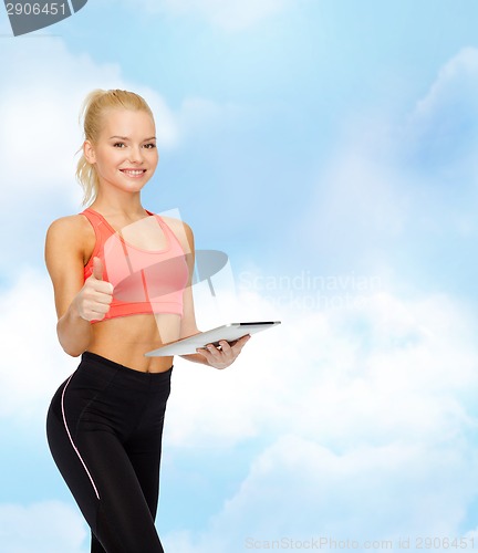 Image of smiling sporty woman with tablet pc computer