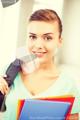 Image of student girl with school bag and color folders