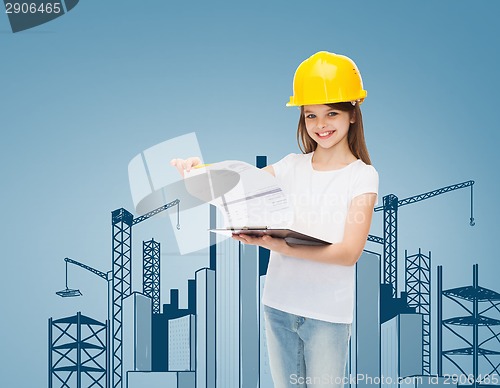 Image of smiling little girl in hardhat with clipboard