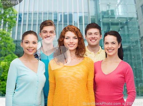 Image of group of smiling teenagers over city background