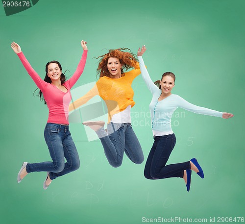 Image of smiling young women jumping in air