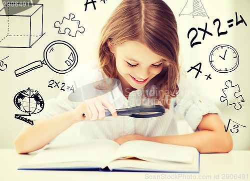 Image of girl reading book with magnifier at school