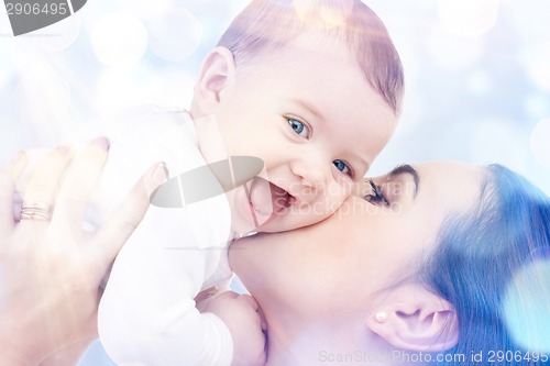Image of happy mother kissing baby