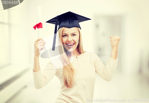 Image of student in graduation cap with certificate