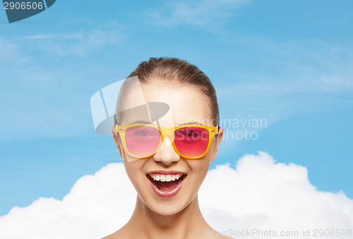 Image of happy teenage girl in pink sunglasses