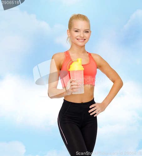 Image of smiling sporty woman with protein shake bottle