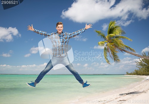 Image of smiling young man jumping in air