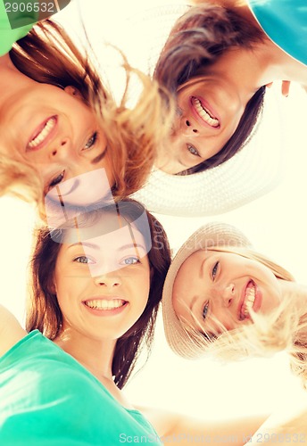 Image of faces of girls looking down and smiling