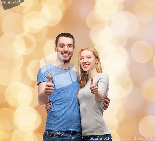 Image of smiling couple showing thumbs up