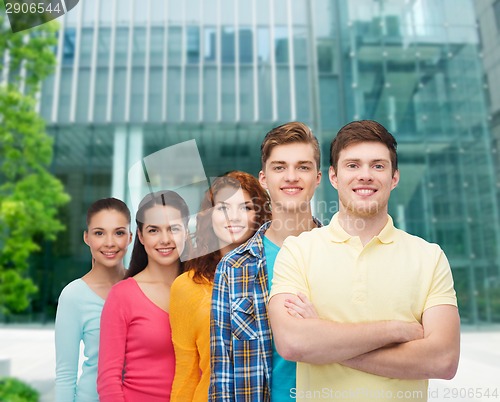 Image of group of smiling teenagers over city background