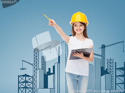 Image of smiling little girl in hardhat with clipboard