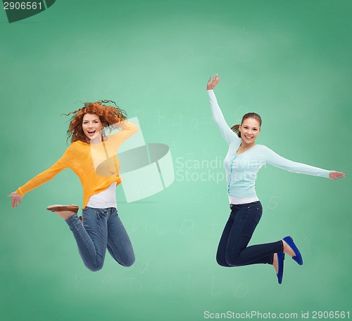 Image of smiling young women jumping in air