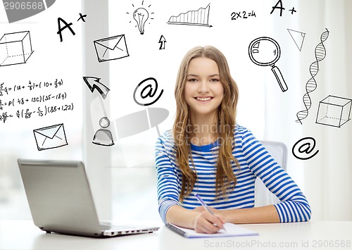 Image of smiling teenage girl laptop computer and notebook