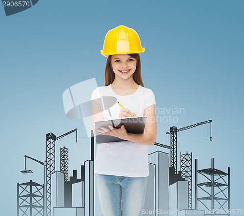 Image of smiling little girl in hardhat with clipboard