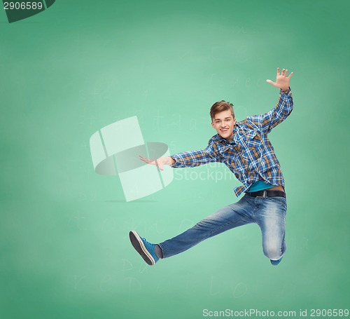 Image of smiling young man jumping in air