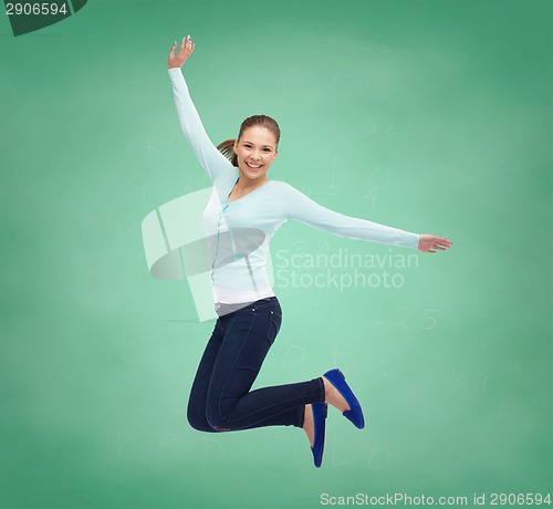 Image of smiling young woman jumping in air