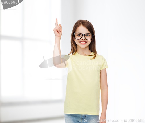 Image of smiling cute little girl in black eyeglasses