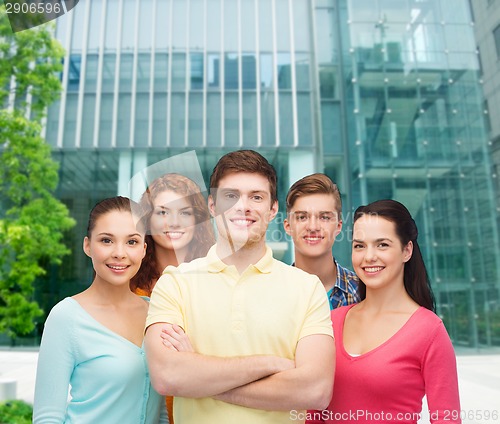 Image of group of smiling teenagers over city background