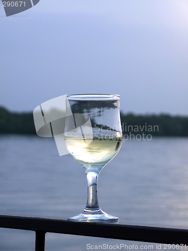 Image of Glass of white wine on a background of the river