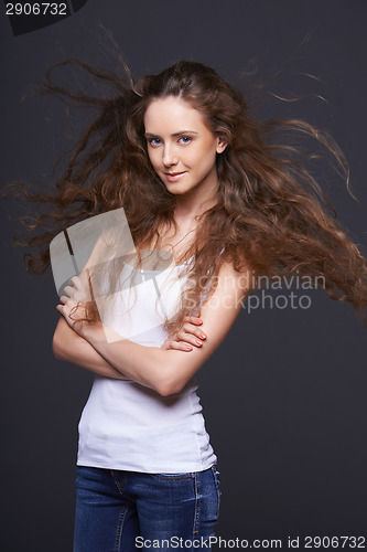 Image of Woman posing with hair fluttering in the wind