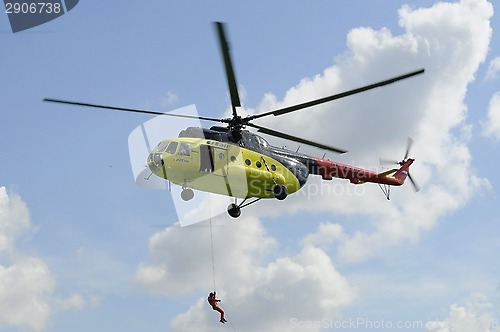 Image of The yellow MI-8 helicopter hanged with an open door. Landing of 