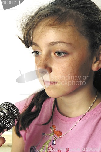 Image of Young girl with karaoke microphone