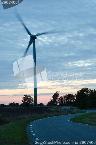 Image of Wind turbine at winding road in a rural landscape