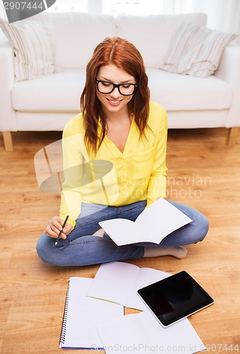 Image of smiling teenage girl with tablet pc at home