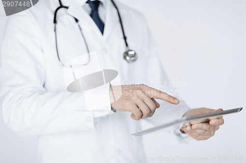 Image of male doctor holding tablet pc