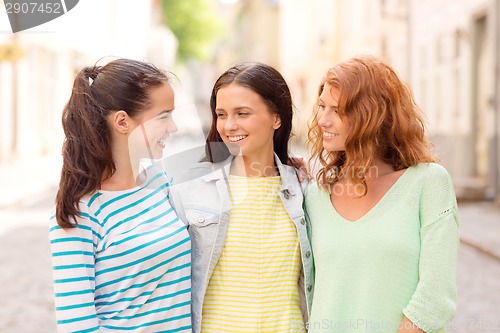 Image of smiling teenage girls with on street