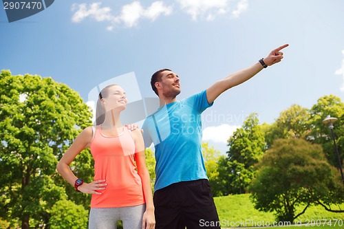 Image of two smiling people outdoors