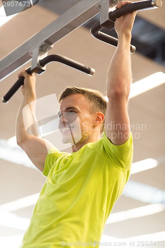 Image of smiling man exercising in gym