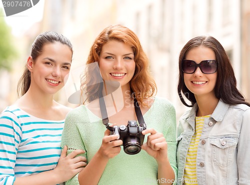 Image of smiling teenage girls with camera